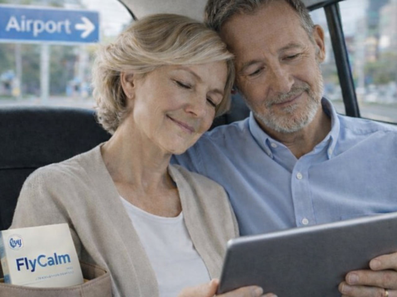 Older couple reading with FlyCalm nearby